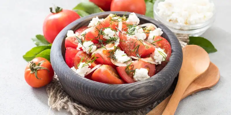 Ensalada de tomate fino con rúcula y requesón